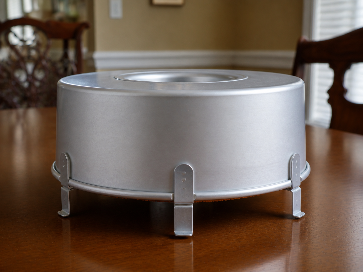 Sugar-free angel food cake cooling upside down in the same footed tube pan