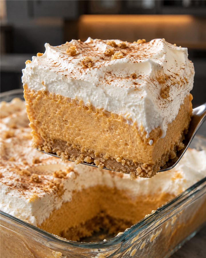 Sugar-free pumpkin fluff dessert square with creamy pumpkin mousse, fluffy topping, cinnamon, and crumb base