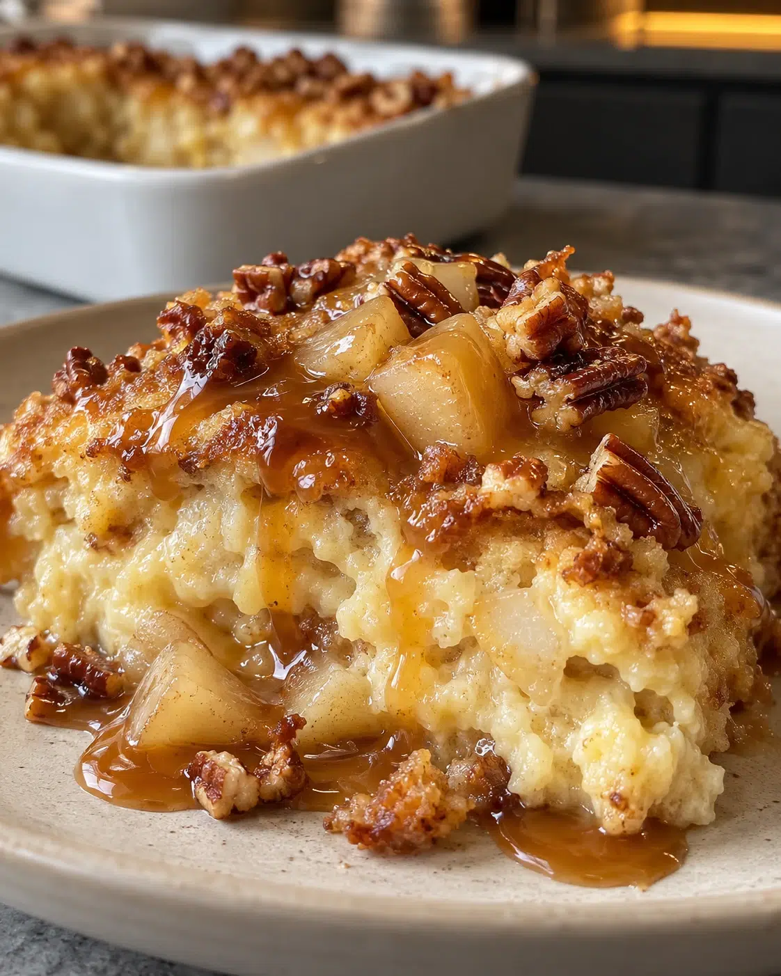 A warm serving of sugar-free caramel pear pudding with pear, pecans and caramel sauce