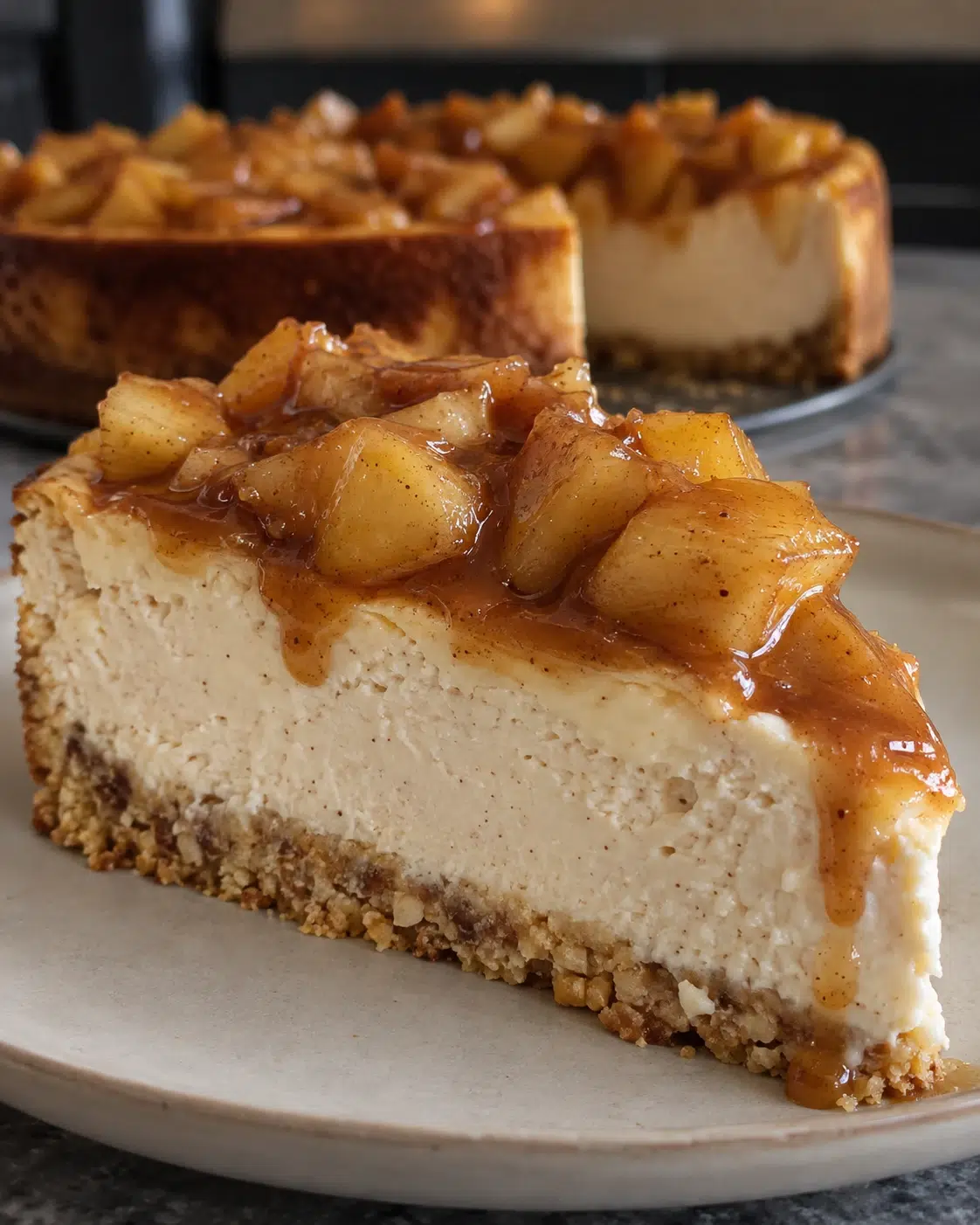 Sugar-free caramel apple cheesecake slice with golden almond crust and glossy cinnamon caramel apples
