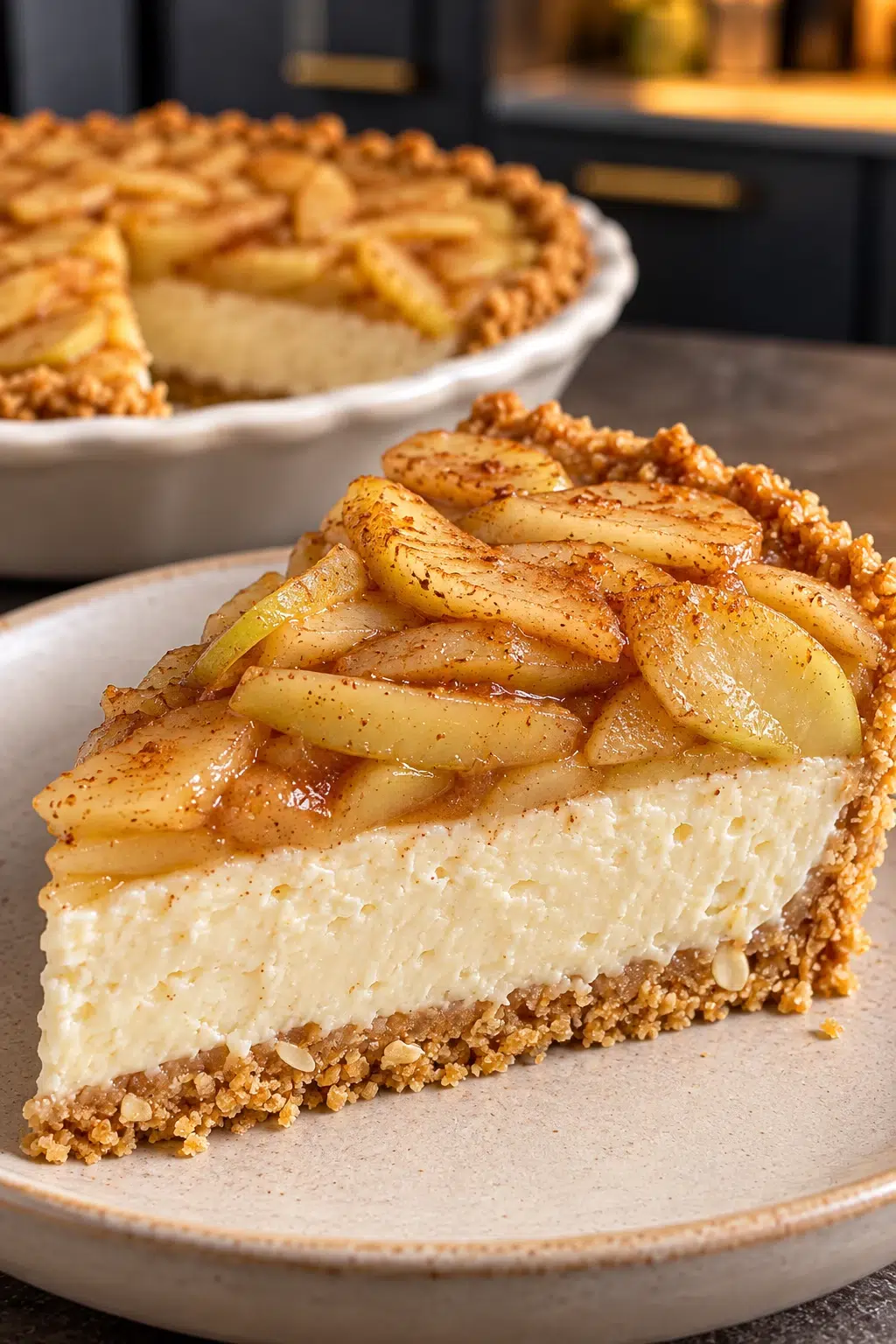 Sugar-free apple cream cheese pie with cinnamon apples in a speckled fluted tart pan