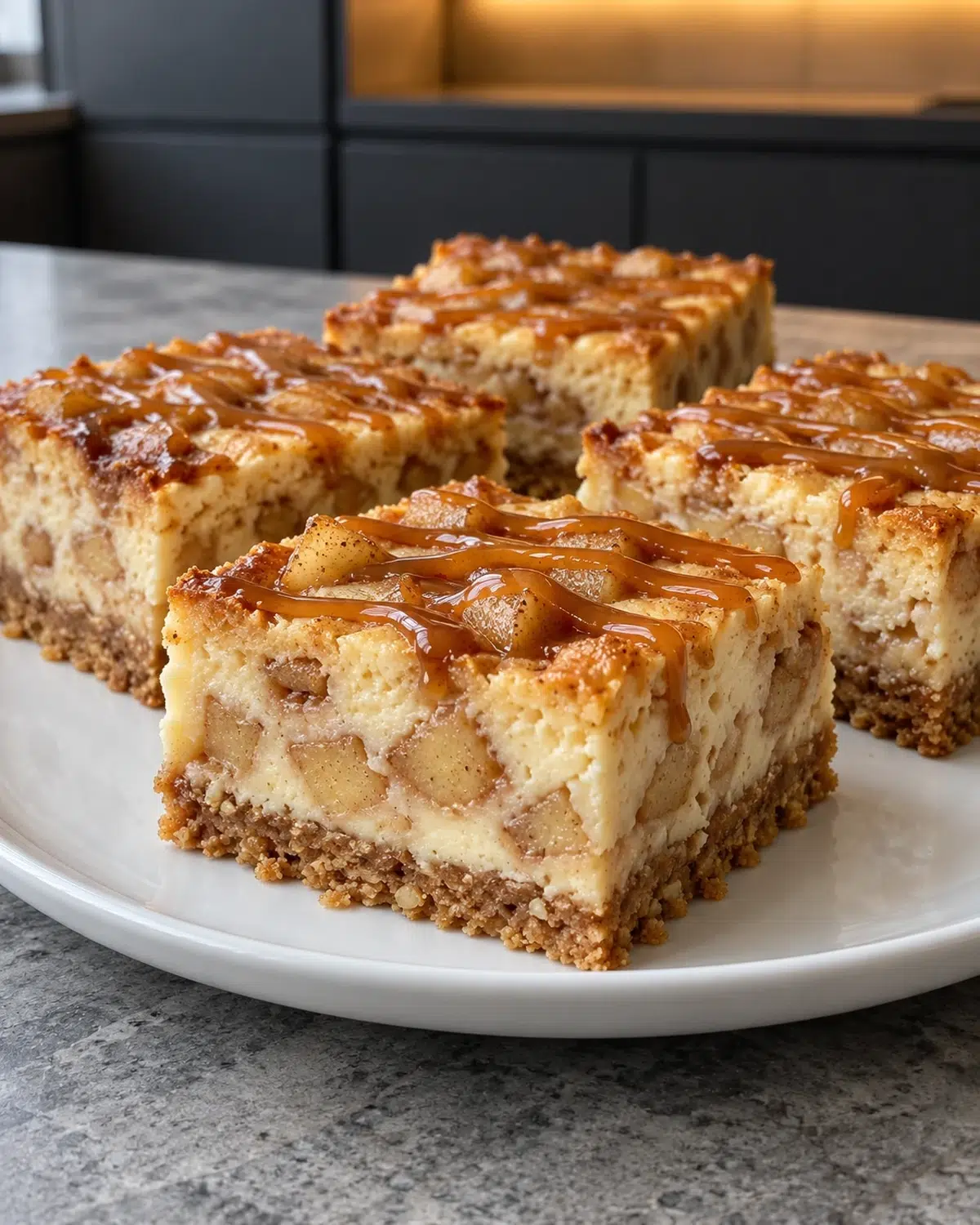 Sugar-free caramel apple cheesecake bars with almond crust, apple filling and caramel drizzle