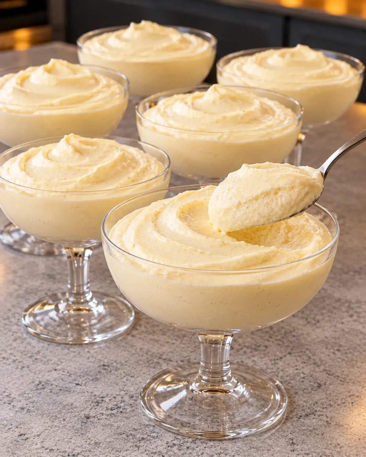 Sugar-free Bavarian cream in clear glass coupes with a spoonful lifted out