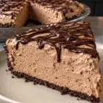Sugar-free mocha cream pie slice with chocolate drizzle on a beige plate